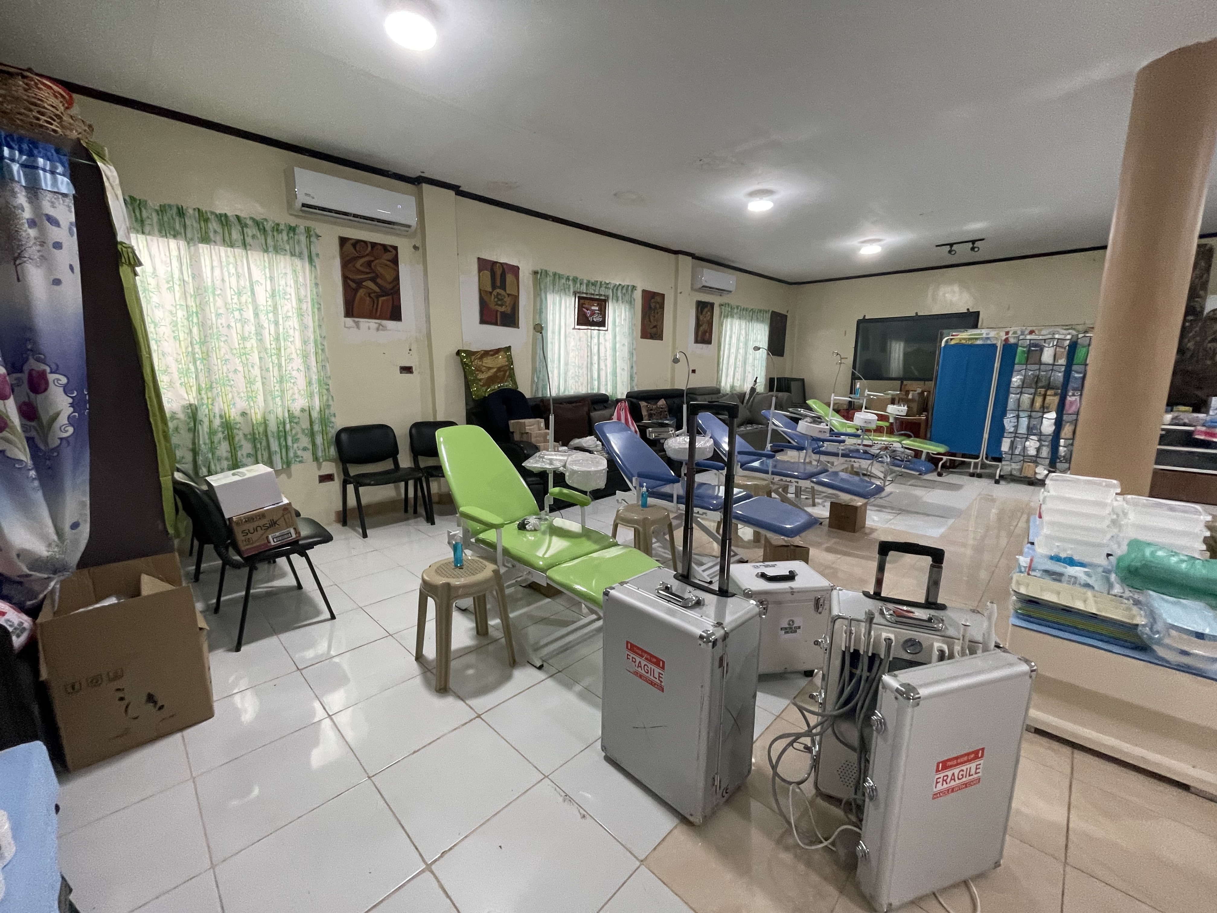 Prepared dental treatment area with portable chairs and clinical equipment in the Philippines mission setting