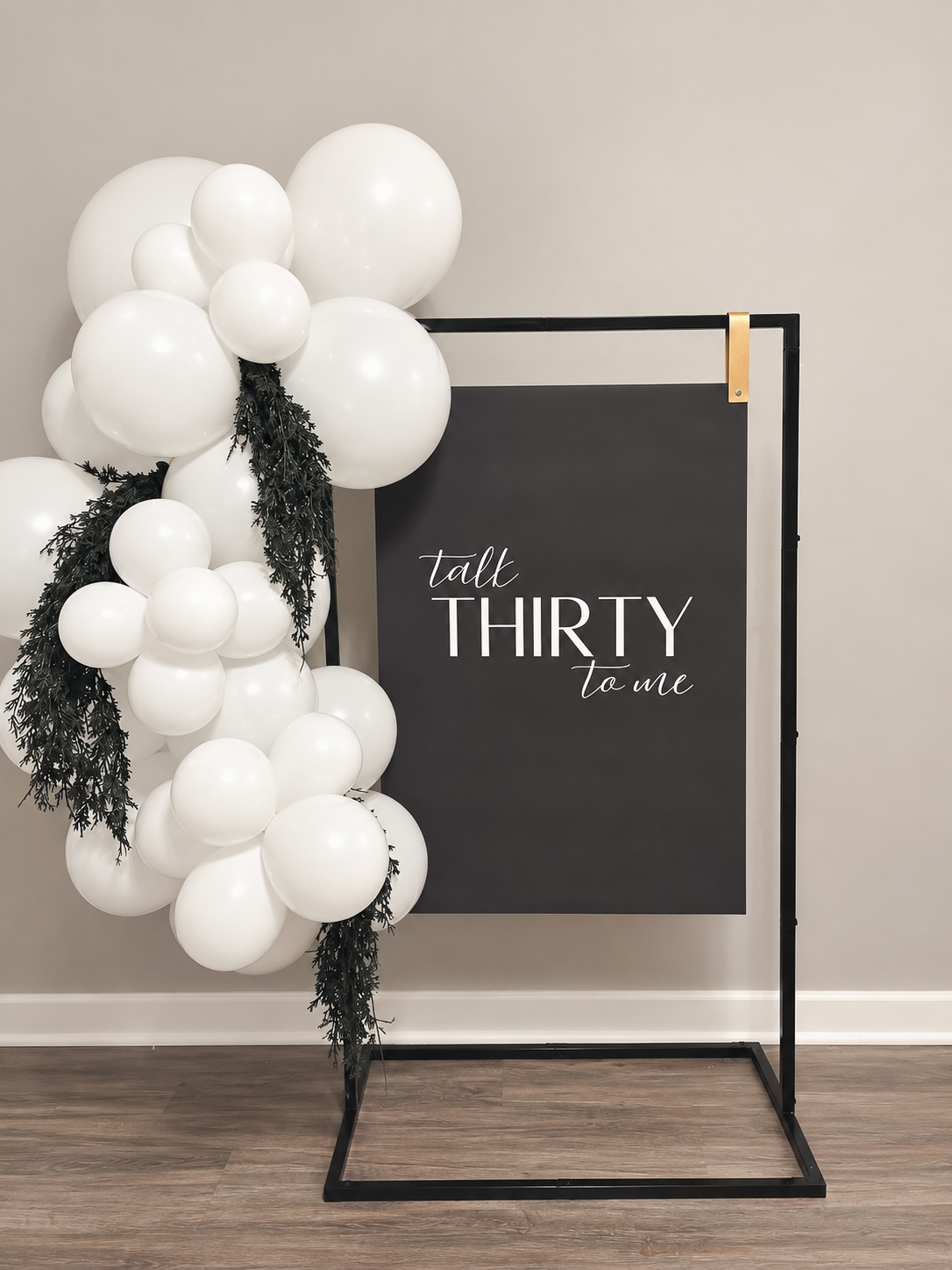 Party welcome sign framed by an ivory balloon garland