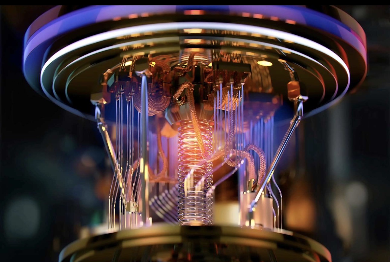 Close-up of illuminated quantum-computing hardware with gold wiring and glass supports.