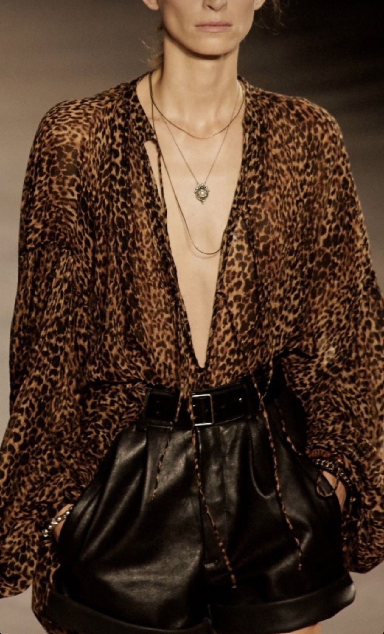 Runway editorial of a model wearing a leopard-print look