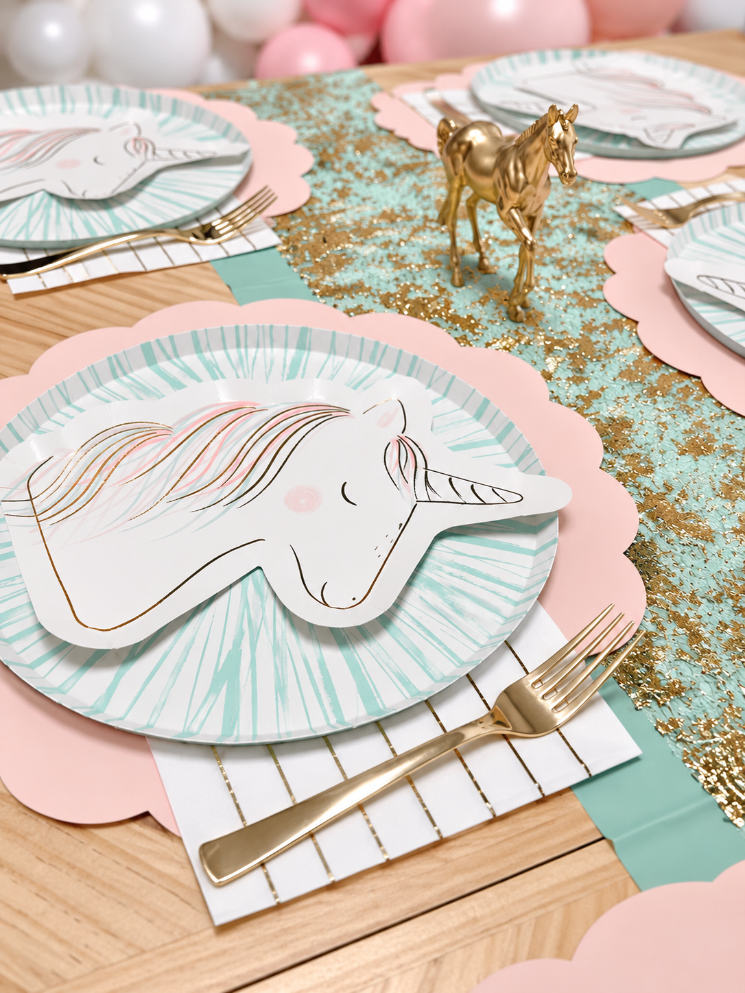 Pink and mint themed party table with playful horse decorations