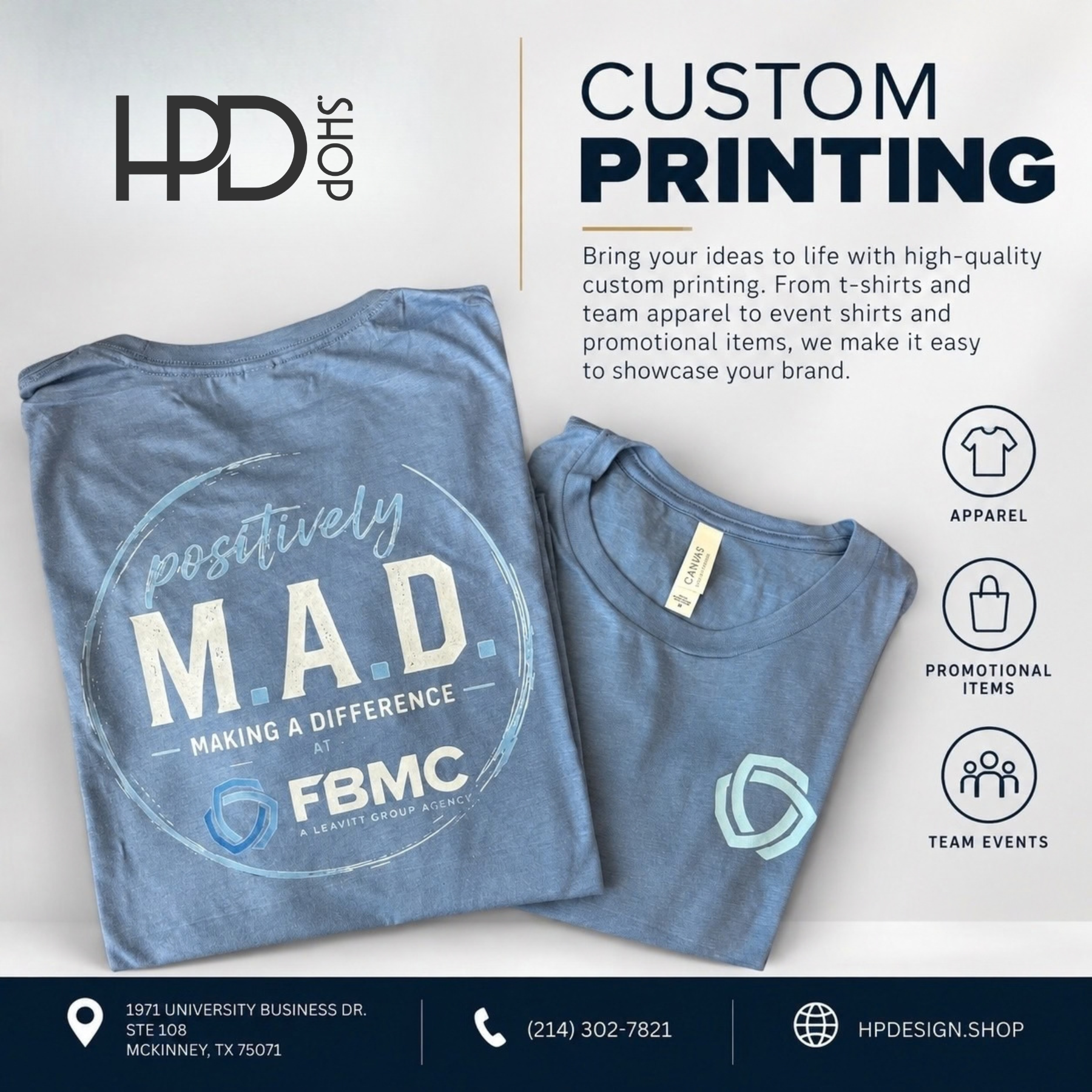 Two folded blue custom-printed T-shirts on a white surface