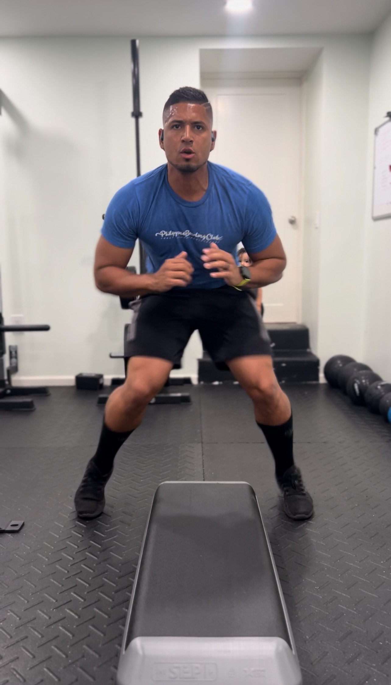 Coach moving through a quick training drill in a home gym