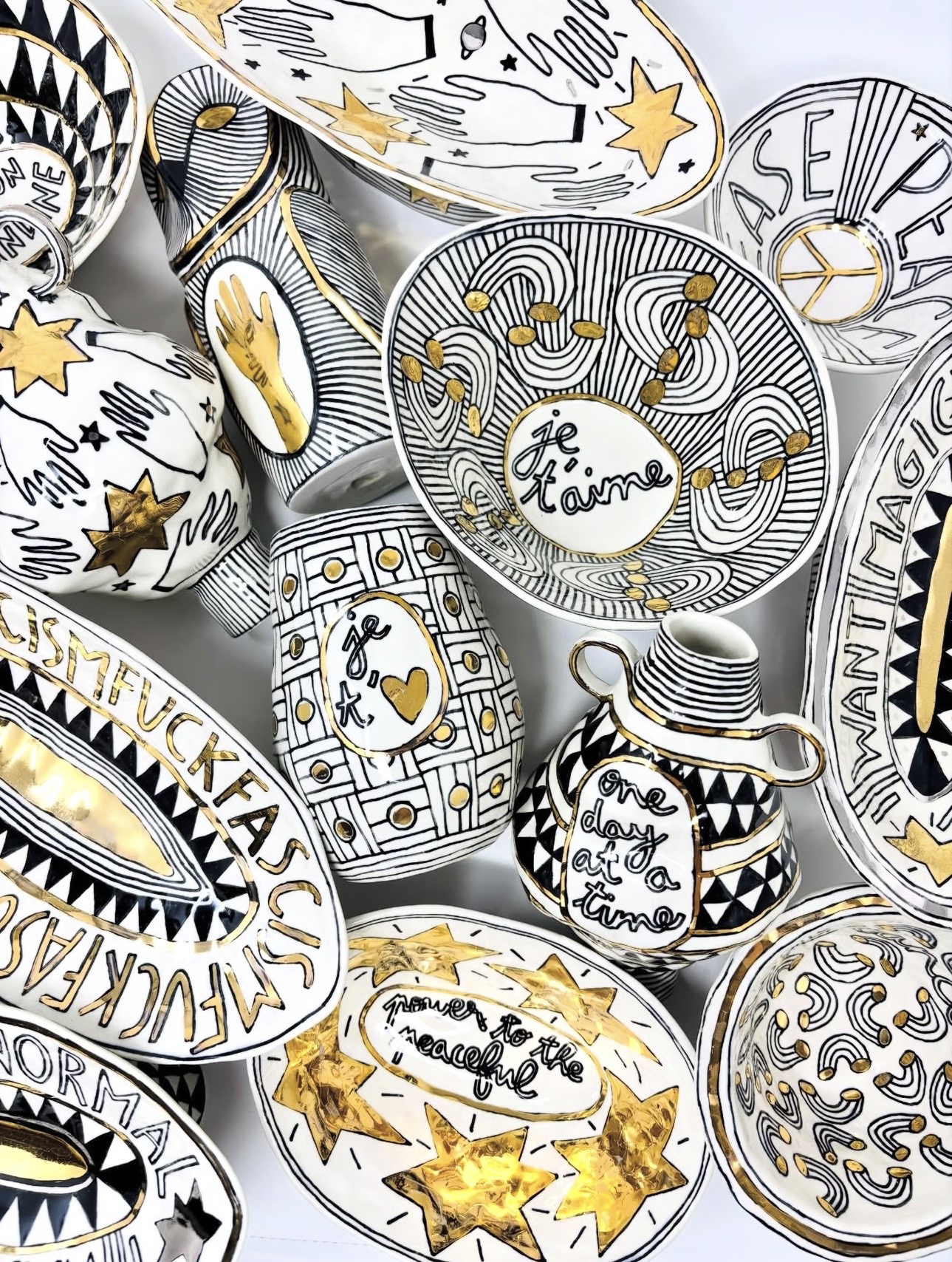 Hand-painted black, white, and gold ceramic tableware