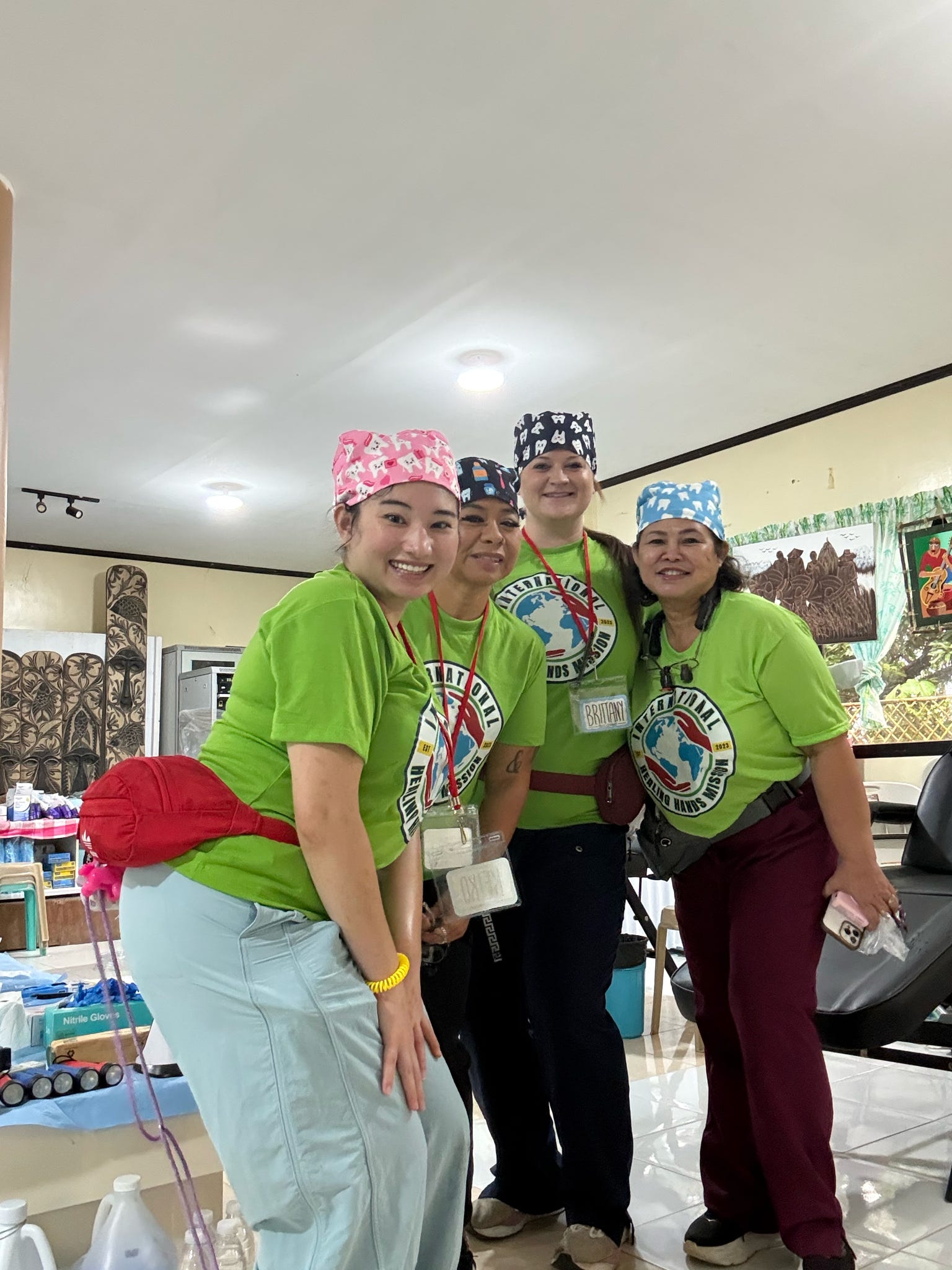 Mission team members in clinical attire preparing inside the treatment space