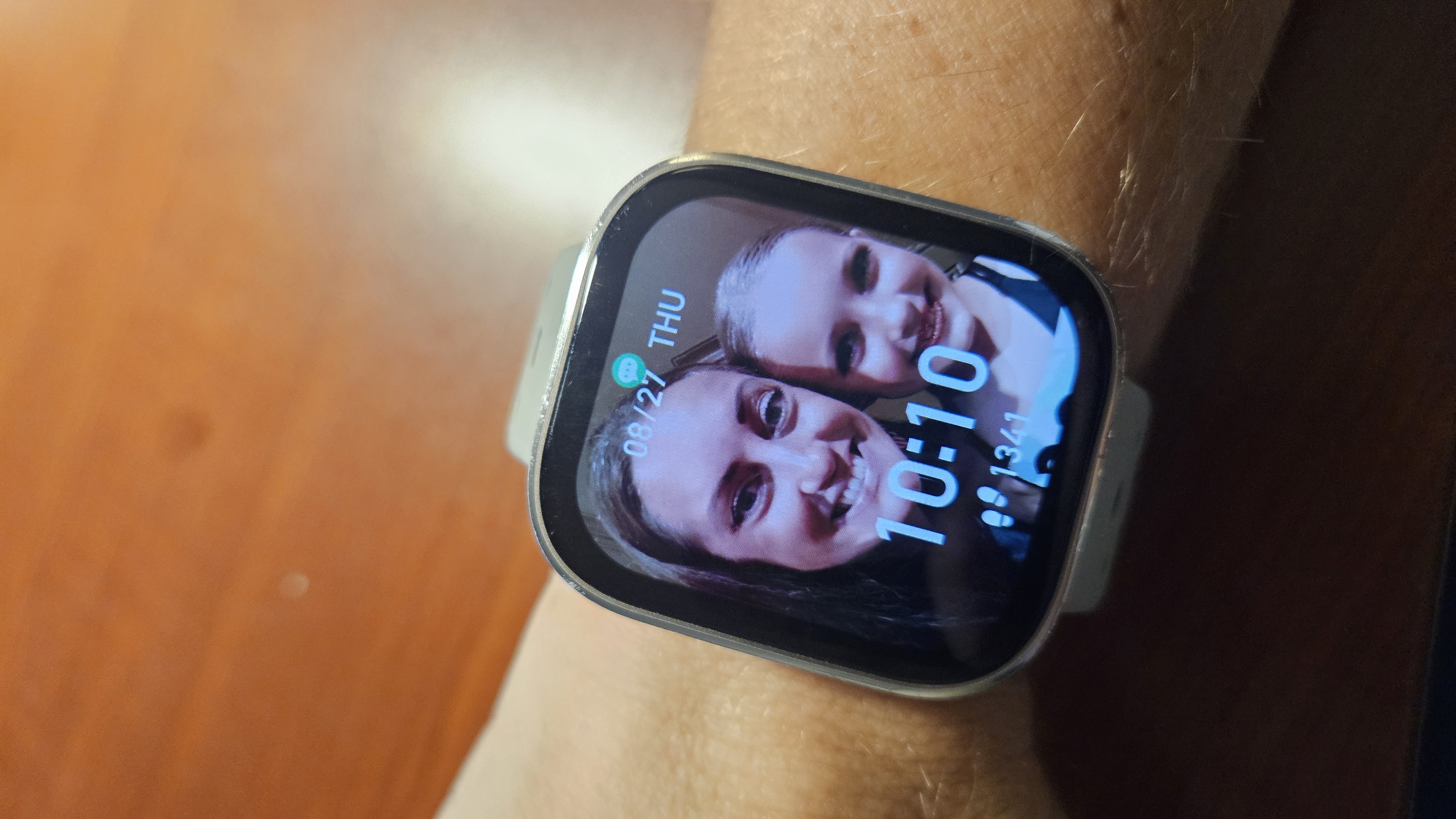 Laura's Amazfit Bip 6 on her wrist with her personal watch face visible.