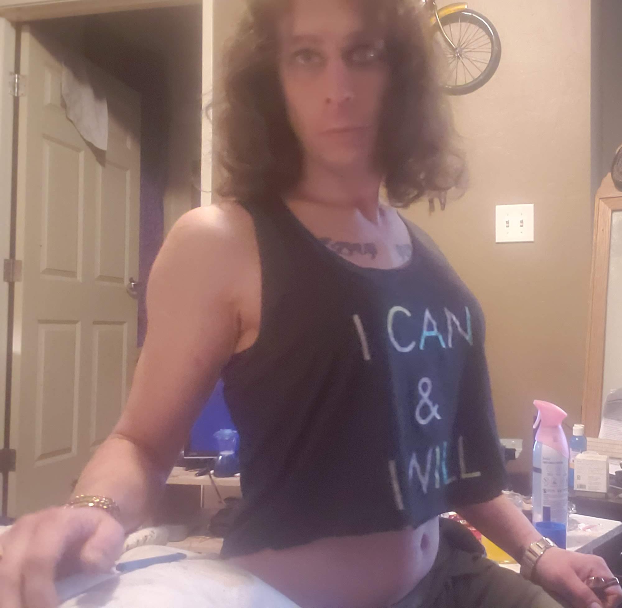 Portrait of Evelyn L'amour wearing a black crop top.