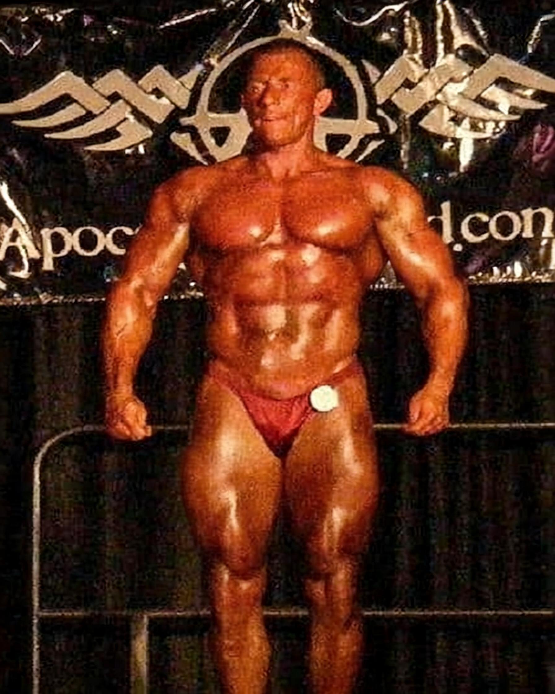 Coach Herb posing during his competitive strength training years