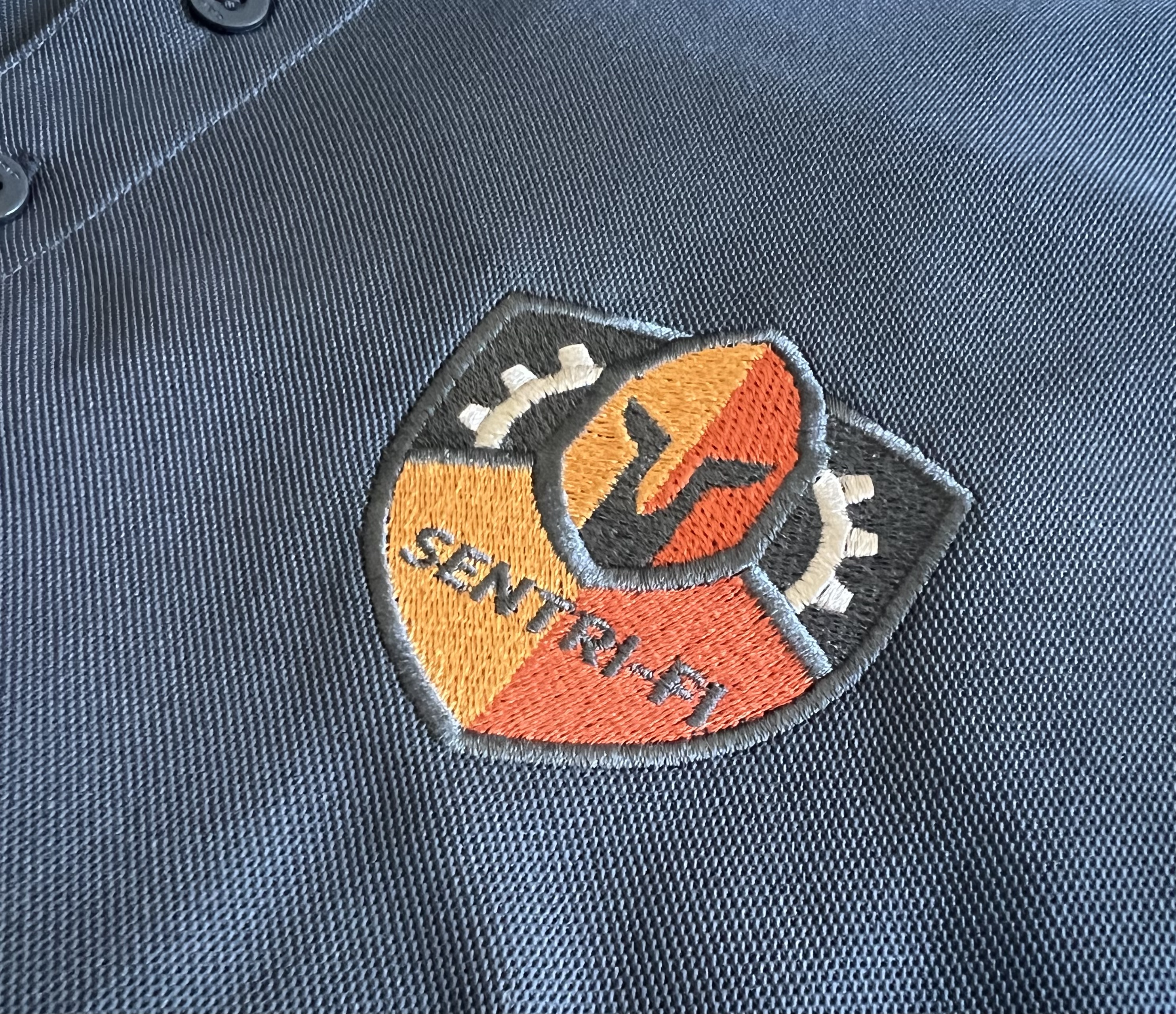 Close-up of an embroidered patch on navy fabric