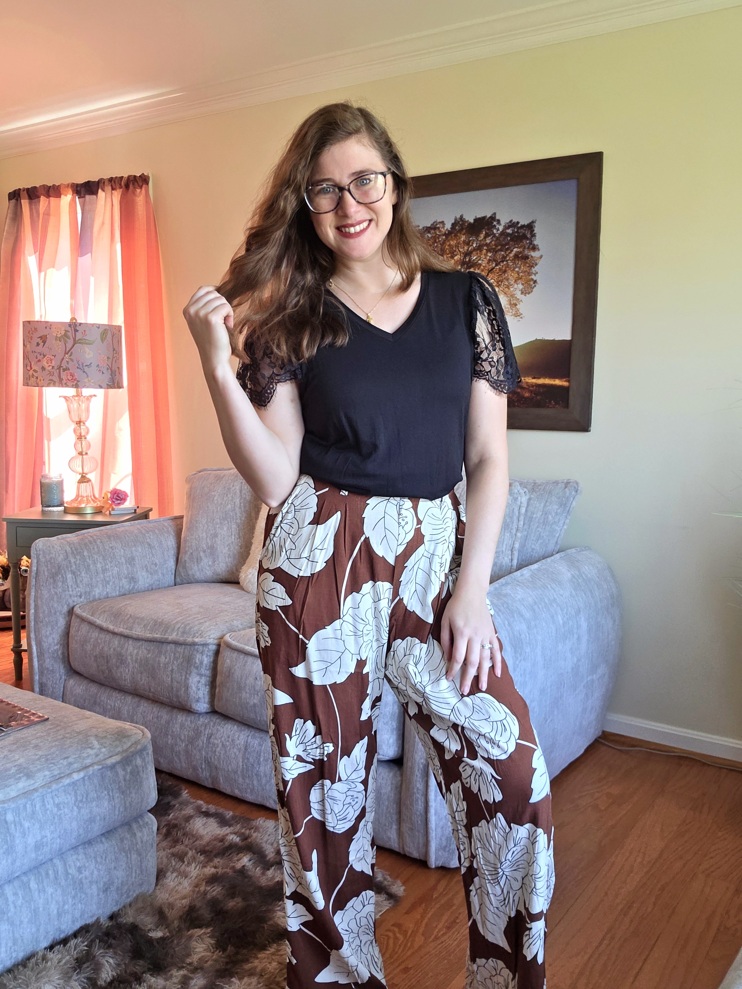 Courtney styling floral wide-leg pants and a black lace sleeve top